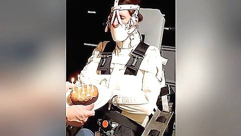 Straitjacket & Muzzled Girl Tries To Blow Out Candles
