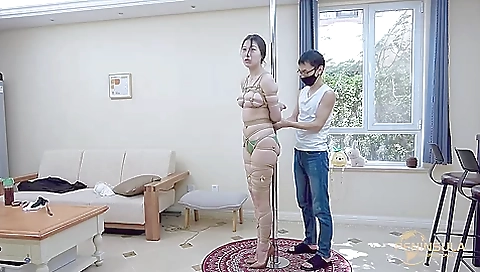 Tied to a pole with dildo gag